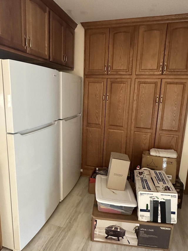 kitchen featuring light hardwood / wood-style floors and white fridge