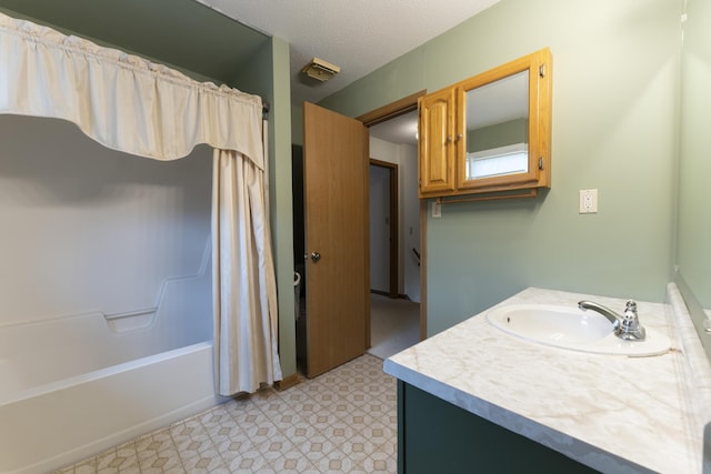 12500 W Rocheport Gravel Rd, Rocheport, MO 65279 - bathroom featuring tile patterned floors, a textured ceiling, vanity, and shower / tub combo
