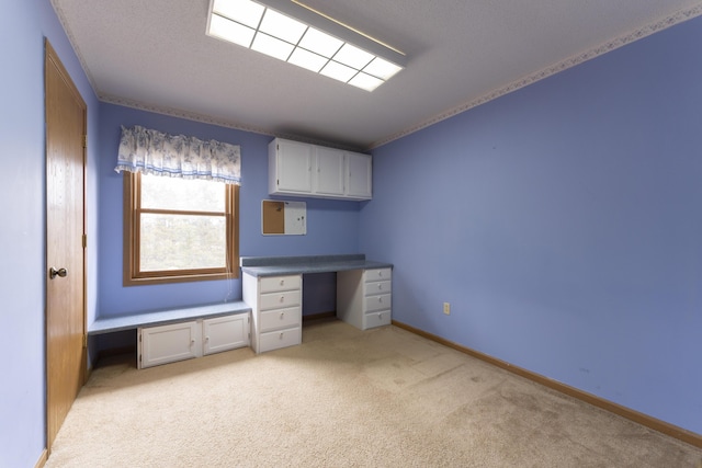12500 W Rocheport Gravel Rd, Rocheport, MO 65279 - unfurnished office featuring a textured ceiling, light colored carpet, baseboards, and built in study area