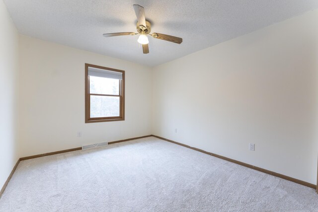 12500 W Rocheport Gravel Rd, Rocheport, MO 65279 - spare room featuring light carpet, visible vents, a textured ceiling, and ceiling fan