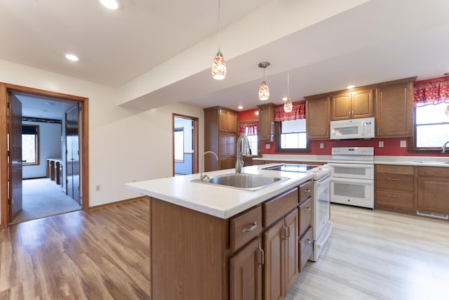 12500 W Rocheport Gravel Rd, Rocheport, MO 65279 - kitchen featuring white appliances, an island with sink, light countertops, and a sink