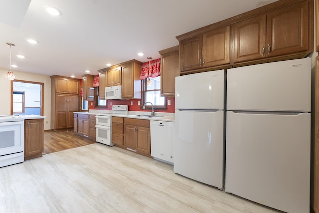 12500 W Rocheport Gravel Rd, Rocheport, MO 65279 - kitchen featuring brown cabinets, a sink, recessed lighting, white appliances, and light countertops
