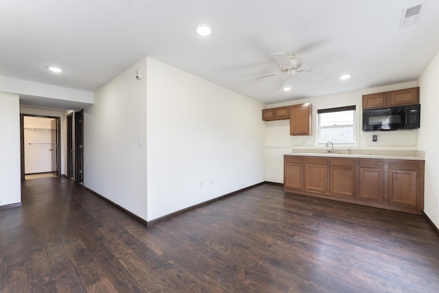 12500 W Rocheport Gravel Rd, Rocheport, MO 65279 - kitchen featuring visible vents, ceiling fan, black microwave, brown cabinets, and dark wood-style floors