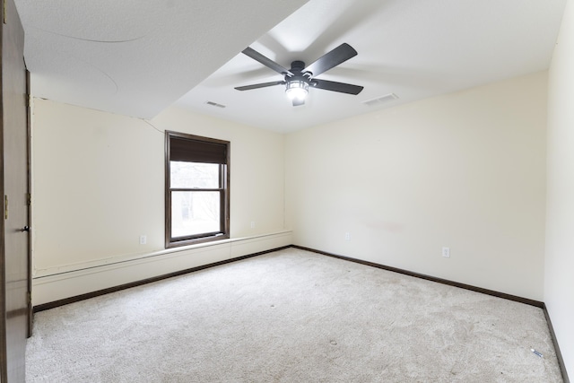 12500 W Rocheport Gravel Rd, Rocheport, MO 65279 - carpeted spare room featuring a baseboard heating unit, a ceiling fan, visible vents, and baseboards