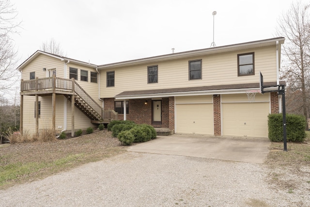 12500 W Rocheport Gravel Rd, Rocheport, MO 65279 - view of front of house with brick siding, an attached garage, stairs, and driveway