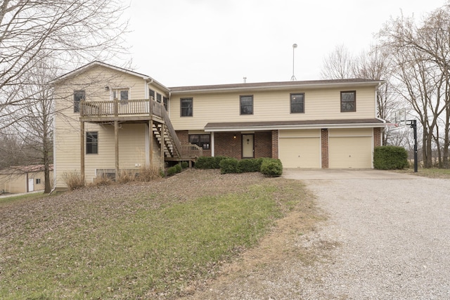12500 W Rocheport Gravel Rd, Rocheport, MO 65279 - view of front of home featuring gravel driveway, an attached garage, brick siding, and stairs