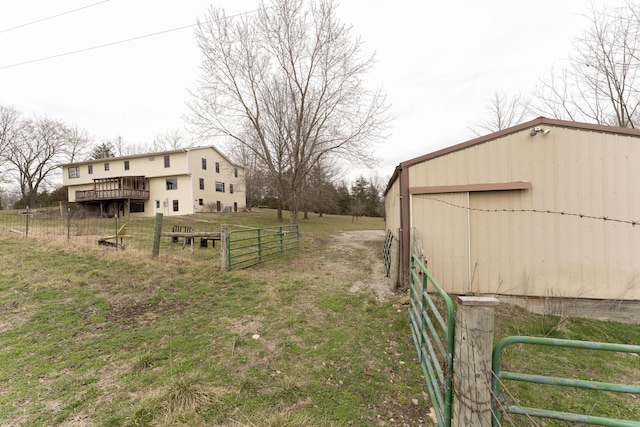 12500 W Rocheport Gravel Rd, Rocheport, MO 65279 - view of yard with fence, a wooden deck, a garage, a pole building, and an outbuilding