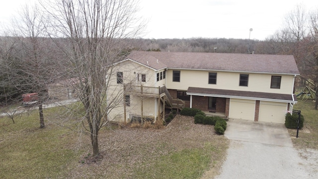 12500 W Rocheport Gravel Rd, Rocheport, MO 65279 - traditional-style home featuring brick siding, an attached garage, concrete driveway, and stairs