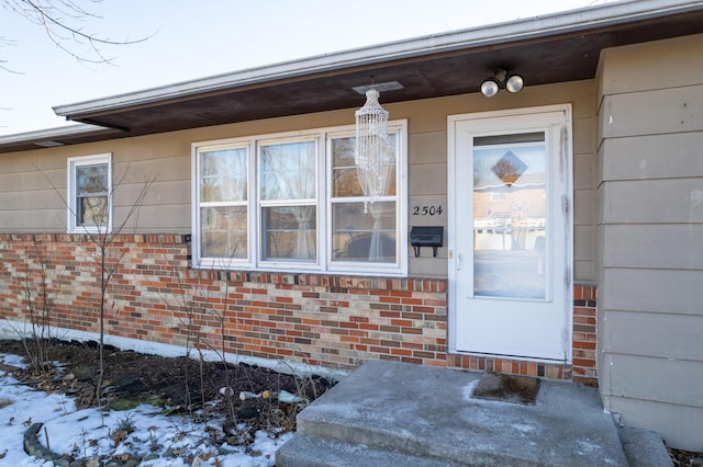 view of snow covered property entrance