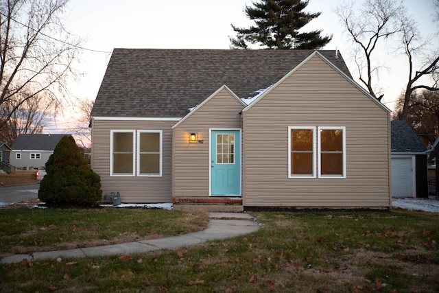 view of front of home with a yard and a garage