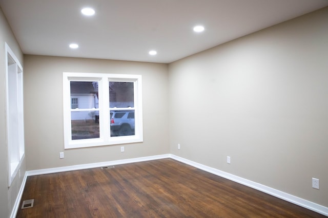 empty room with dark wood-type flooring