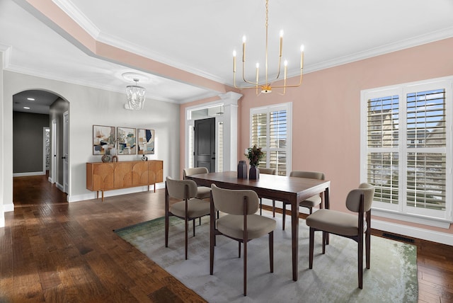 dining room featuring an inviting chandelier, crown molding, and dark hardwood / wood-style floors