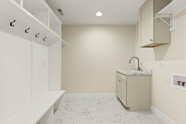 clothes washing area with marble finish floor, hookup for a washing machine, visible vents, and baseboards