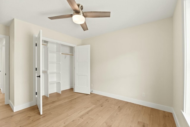 unfurnished bedroom featuring a closet, light wood-type flooring, a ceiling fan, and baseboards