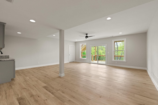 unfurnished living room featuring a ceiling fan, baseboards, recessed lighting, and light wood-type flooring
