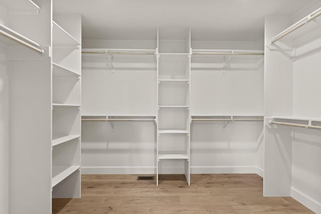 walk in closet featuring wood finished floors and visible vents
