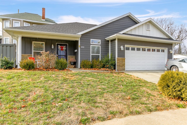 view of front of property with a garage and a front lawn