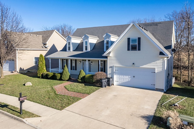 new england style home with covered porch, a garage, and a front lawn