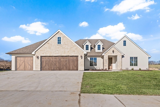 view of front of house with a garage and a front lawn