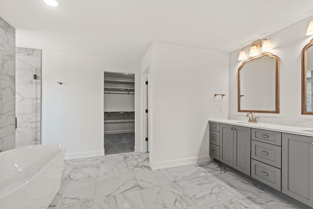 bathroom featuring a tub to relax in and vanity