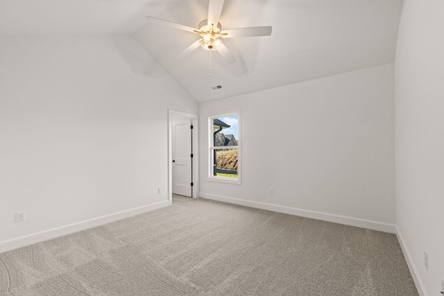 empty room with light carpet, ceiling fan, and lofted ceiling