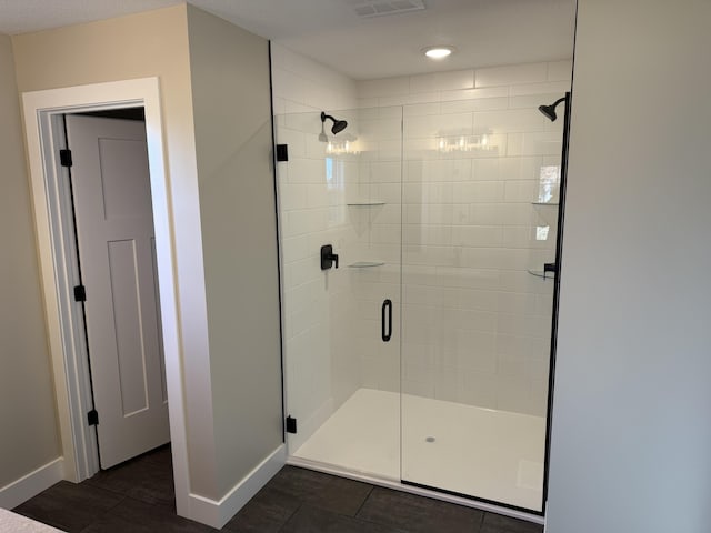 bathroom with tile patterned floors and walk in shower