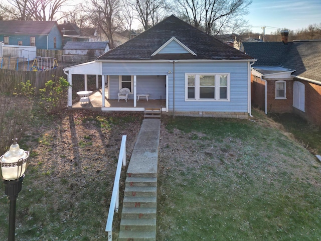 bungalow-style home featuring a porch and a front lawn