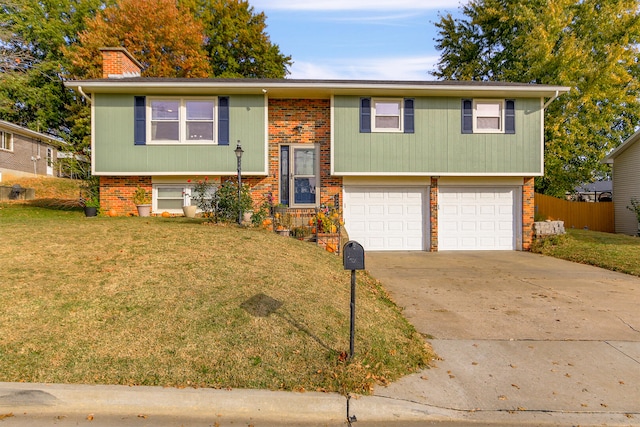 raised ranch featuring a front lawn and a garage