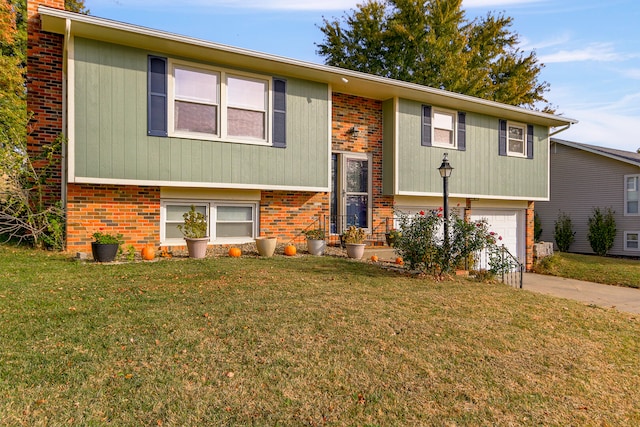 bi-level home with a front yard and a garage