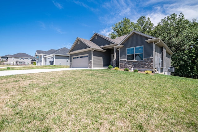 craftsman house featuring a front yard and a garage