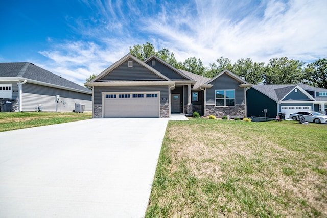 craftsman inspired home with central air condition unit, a front lawn, and a garage