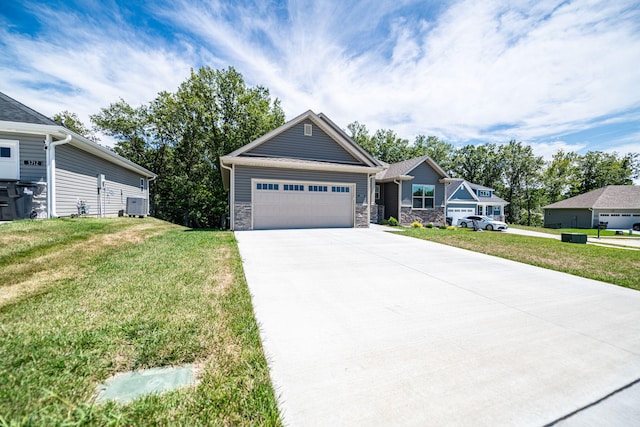 view of front of property featuring a garage, central air condition unit, and a front lawn