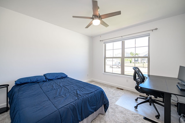 bedroom with ceiling fan and light carpet