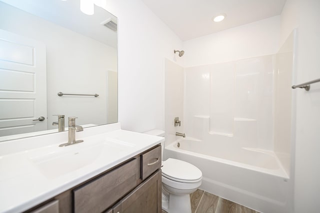 full bathroom with bathtub / shower combination, hardwood / wood-style floors, vanity, and toilet