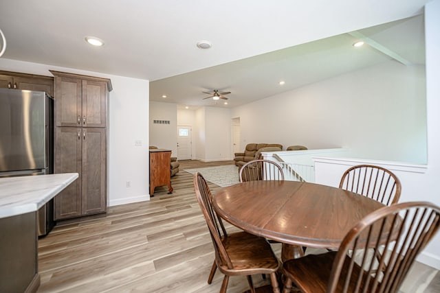 dining room with ceiling fan and light wood-type flooring