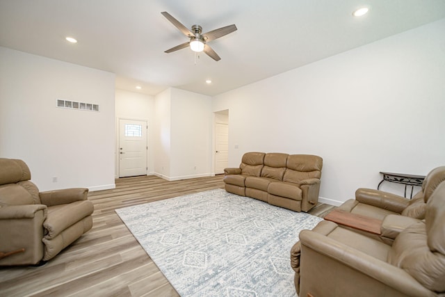 living room featuring ceiling fan and light wood-type flooring