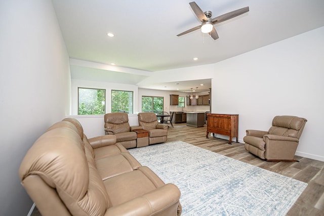 living room featuring ceiling fan and light hardwood / wood-style floors