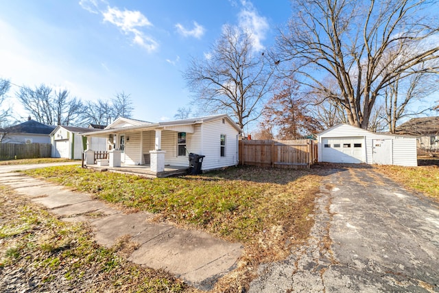 ranch-style home with an outbuilding, covered porch, and a garage