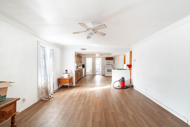 misc room with ceiling fan, light hardwood / wood-style flooring, and ornamental molding