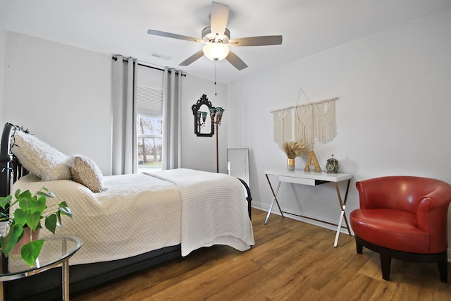 bedroom with ceiling fan and dark wood-type flooring