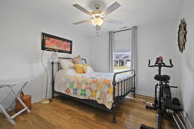 bedroom with wood-type flooring and ceiling fan