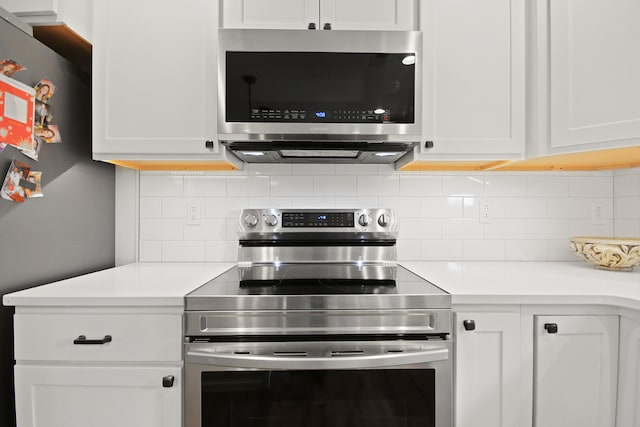 kitchen with white cabinets and appliances with stainless steel finishes