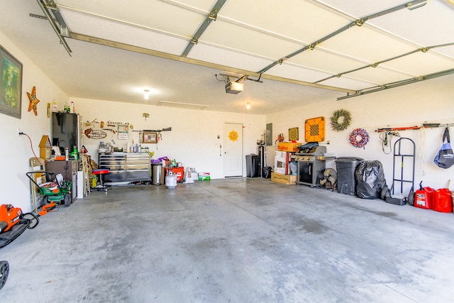 garage with electric panel and a garage door opener