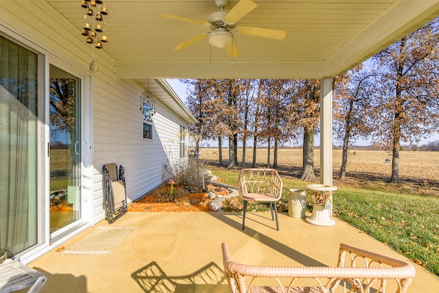 view of patio featuring ceiling fan and a rural view