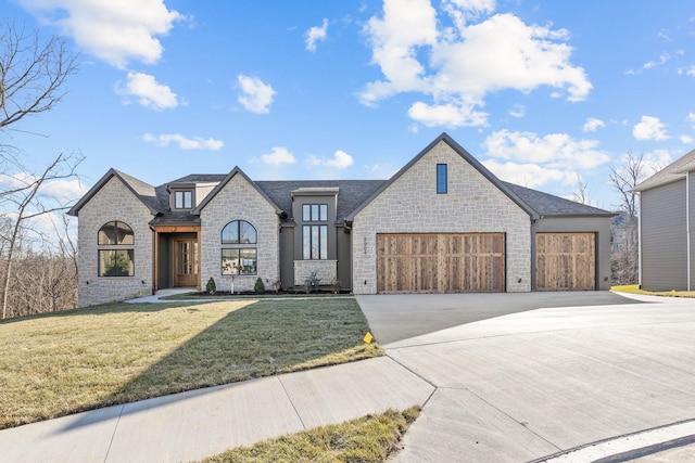 view of front of property featuring a front yard and a garage