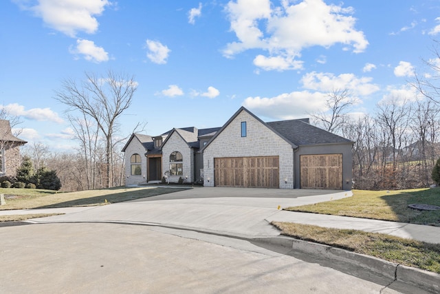 view of front of property with a front yard and a garage