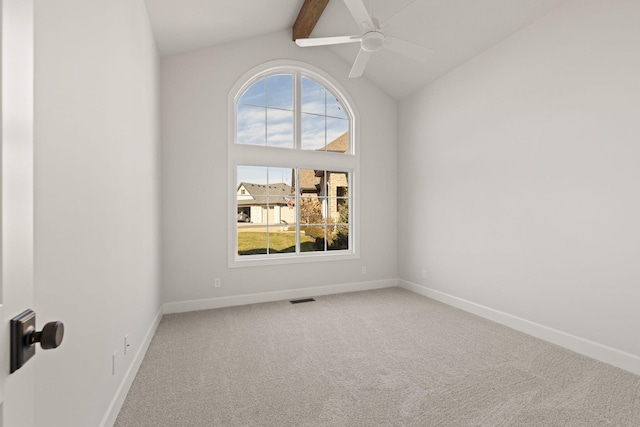 carpeted spare room featuring vaulted ceiling with beams and ceiling fan