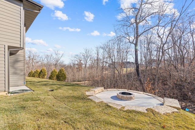 view of yard with a fire pit