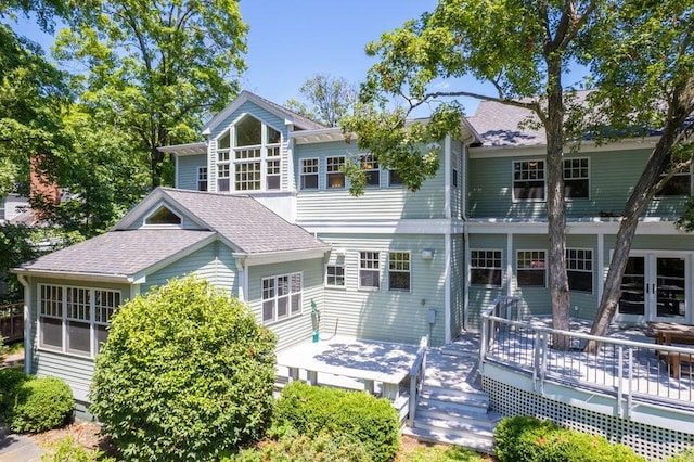 back of property with a wooden deck