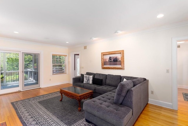 living room with light hardwood / wood-style floors and ornamental molding